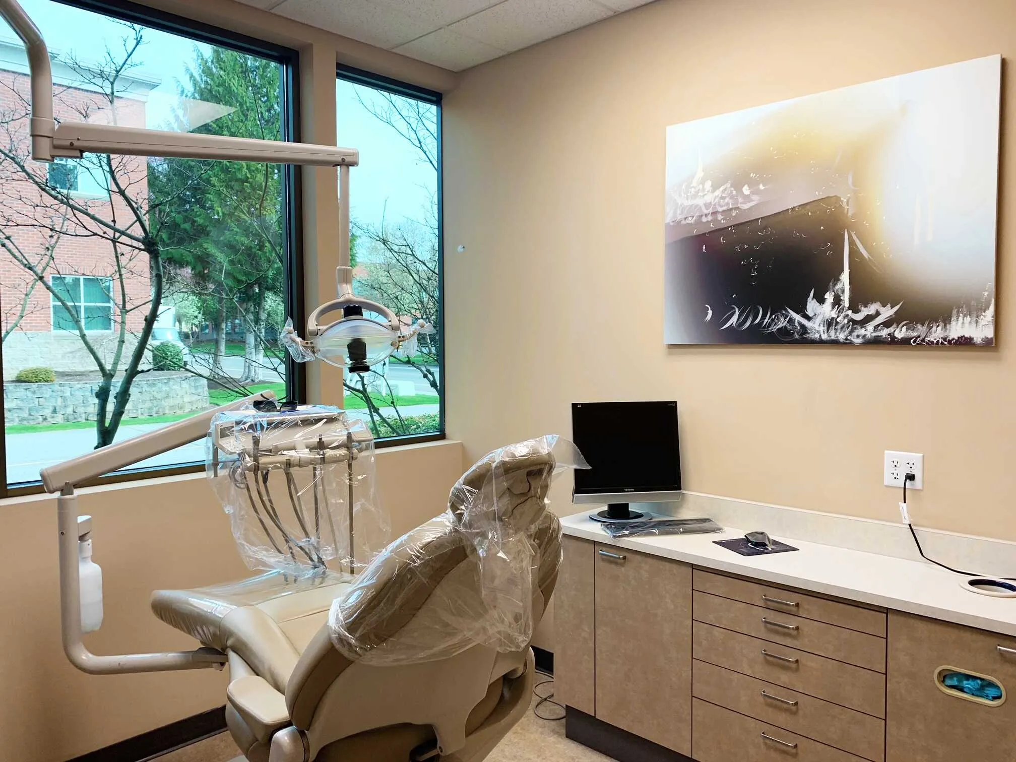 Treatment room with large window views and dental equipment