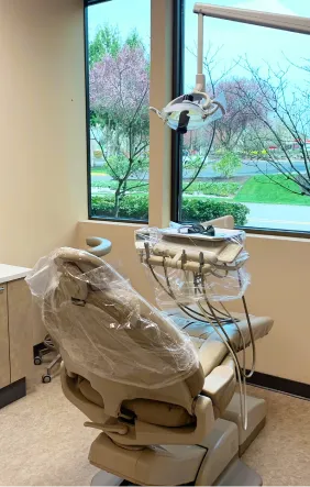 Modern dental treatment room with bright window views
